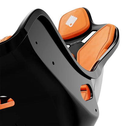 Close-up of the orange cushions and side opening on the black-shell SIMGASM Atlas Formula seat